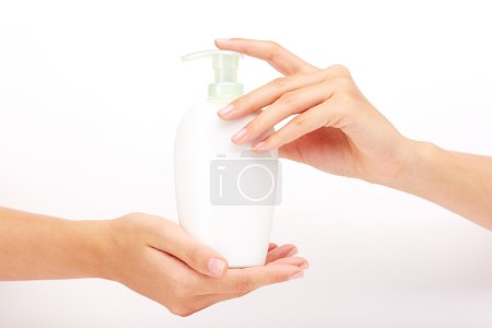 Female hands presenting liquid soap