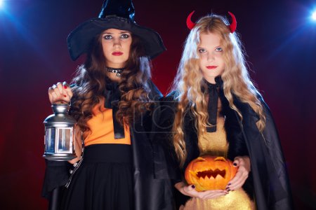 Girls with lantern and pumpkin