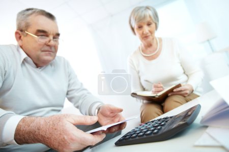 Senior people planning home finances