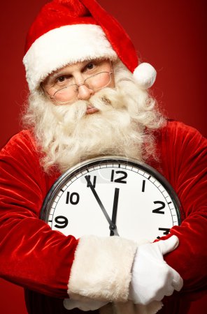 Santa Claus holding clock