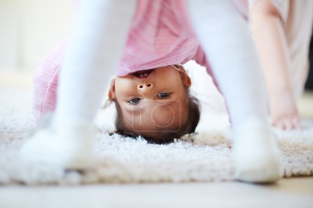 Little girl standing upside-down