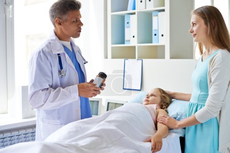 Girl and mother looking at doctor