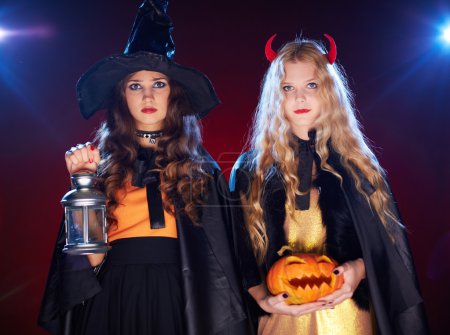 Girls with lantern and pumpkin