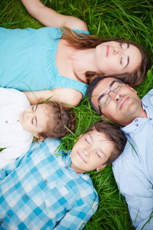 Family relaxing on grass