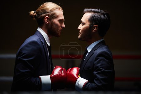 Businessmen in boxing gloves
