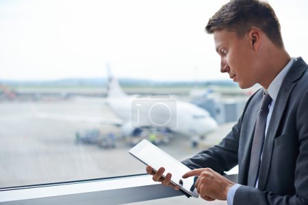 Businessman using touchpad in airport