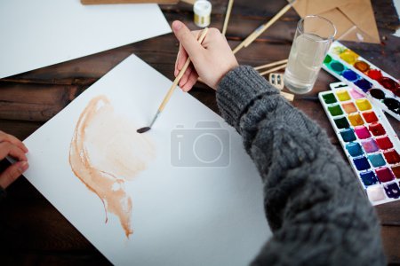 Man drawing with water-colors