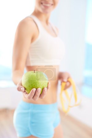 Woman holding green apple