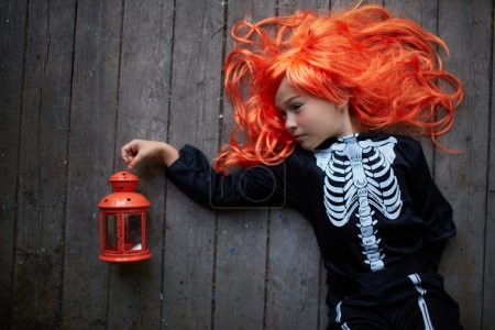 Girl in red wig and Halloween costume
