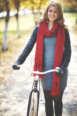 Woman with bike in autumn park