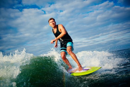 Surfboarder riding on waves