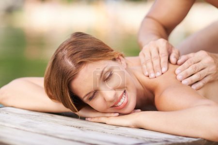 Woman enjoying massage outdoors