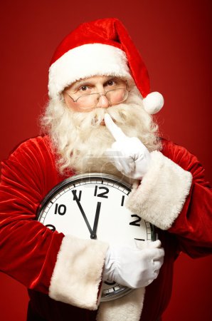 Santa holding Christmas clock