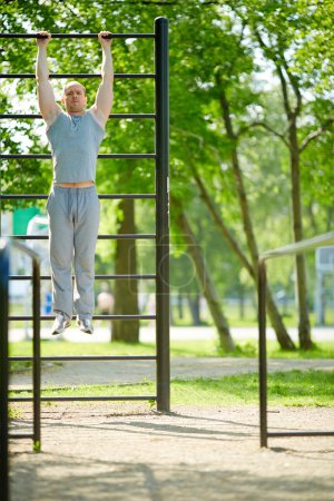 Man pulling up on sport equipment