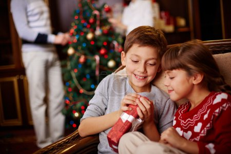 Children opening Christmas gift