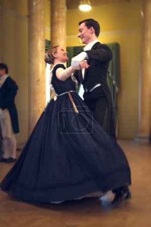 Young couple dancing the waltz in the ballroom
