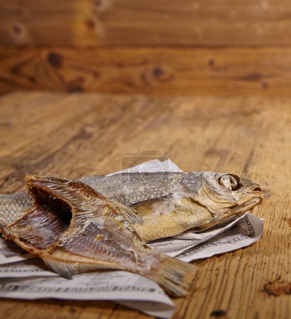 Dried fish on old newspaper