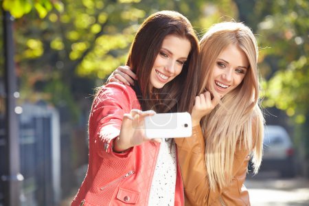 Women making selfie and grimacing