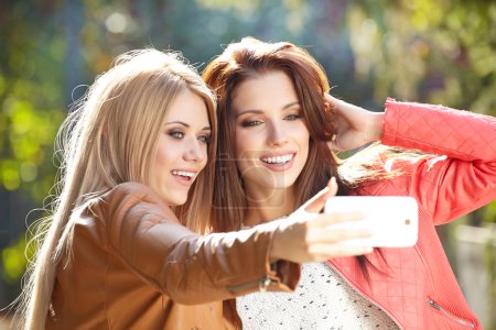 Women making selfie and grimacing
