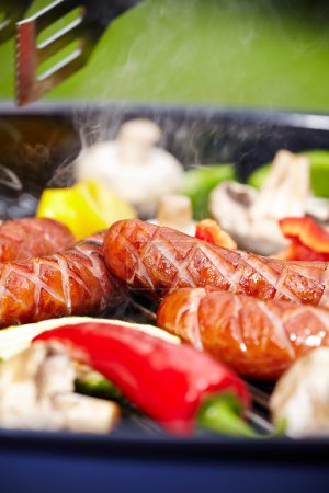BBQ with fiery sausages on the grill 