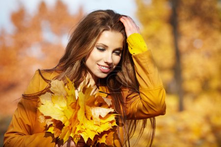 Autumn woman with leaves