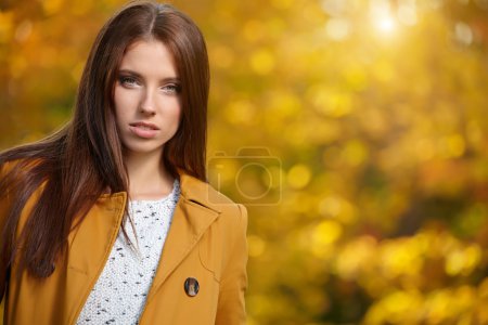 Autumn woman in golden park