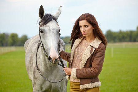 Woman long hair next horse