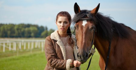Attractive young woman with a horse