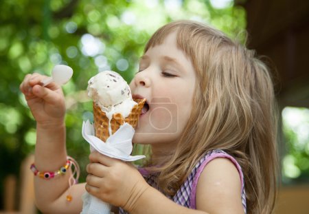 Pretty little girl eating an ice cream