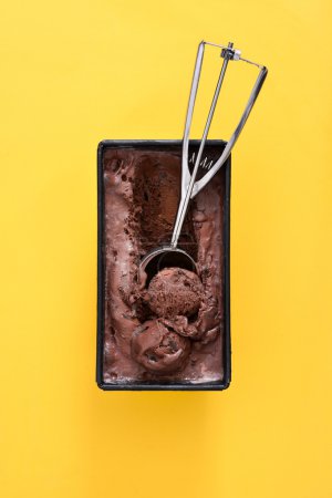 Chocolate ice cream on yellow background