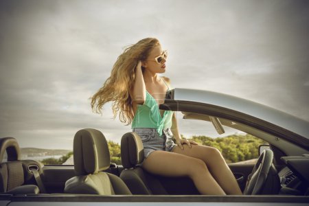 Beautiful girl sitting in a car
