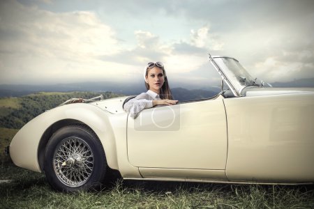 Classy woman in a vintage car