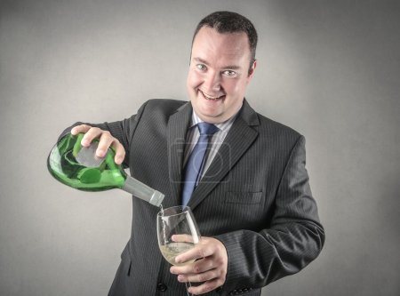 Cheerful businessman pouring wine