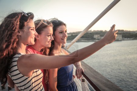 Three friends taking a photo of themselves on vacation