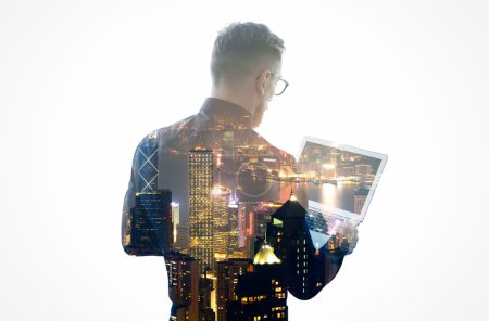 Double exposure young bearded businessman wearing black shirt, glasses and holding contemporary notebook hands. Isolated white, night city background. Horizontal mockup, color
