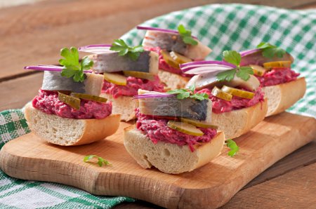 Sandwiches with herring, beetroot and pickled cucumber