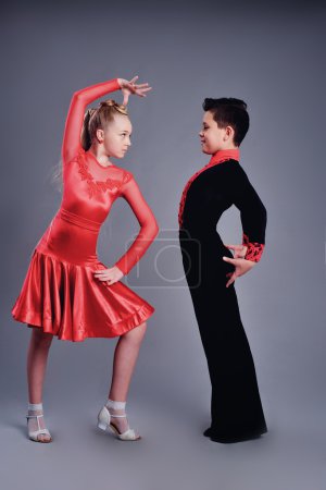 Two beautiful children dancing ballroom dance sport