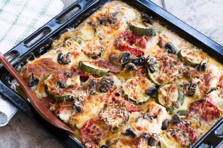 Baked chicken breasts with zucchini, tomatoes, mushrooms and cheese