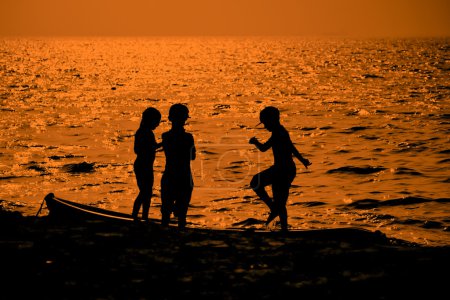 silhouette of Kids playing and walking on beach
