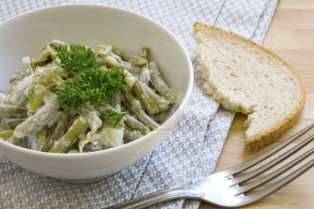 salad of green beans with sour cream dressing and parsley garnis