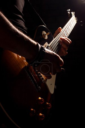 musician playing on guitar