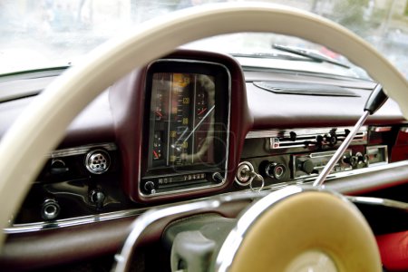 Fragment of interior retro car with speedometer, toggle switches