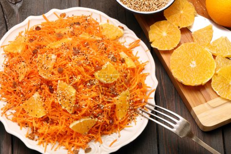 Christmas salad from carrots with orange, raisins and roasted se