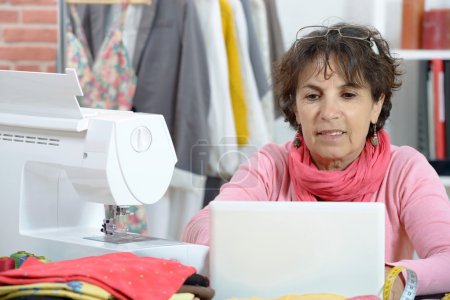 Lovely fashion designer working on the laptop