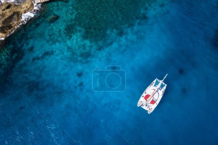 Amazing view to Catamaran cruising in open sea at windy day. Drone - birds eye angle Coco Island
