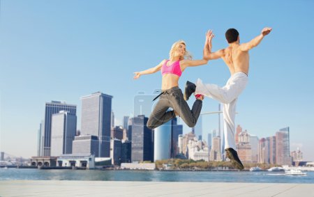 Cheerful young couple training together