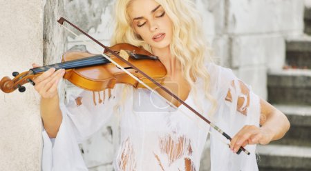 Focused woman playing the violin