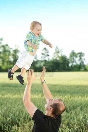 Caring father tossing his son