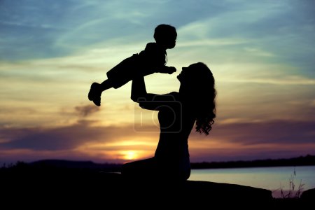Woman lifting up her child