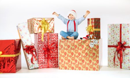 Small cute boy sitting on the gift